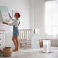 Woman in a nursery with the Ionmax Lavish ION350 Hepa Air Purifier