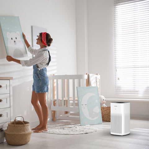 Woman in a nursery with the Ionmax Lavish ION350 Hepa Air Purifier